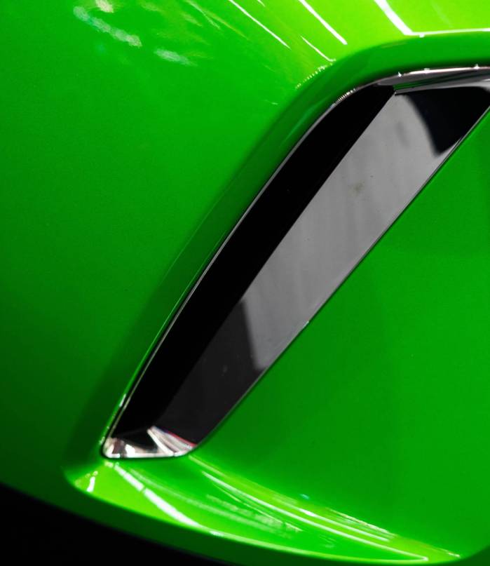 detail-of-a-modern-exhaust-on-a-green-car-2023-11-27-05-17-19-utc-min-min